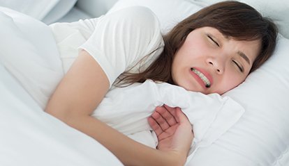 A woman clenching her jaw