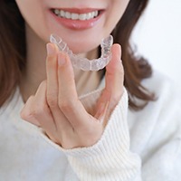A woman holding a custom nightguard