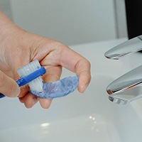 A man cleaning his mouthguard