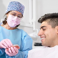 Patient in St. Albans talking to dentist about dental crowns