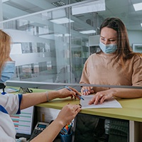 Patient in St. Albans filling out paperwork for dental crowns