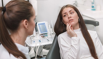 a woman speaking with an emergency dentist