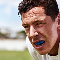 Closeup of man wearing blue mouthguard