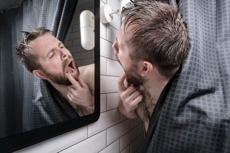 Patient checking their dental implants for cavities